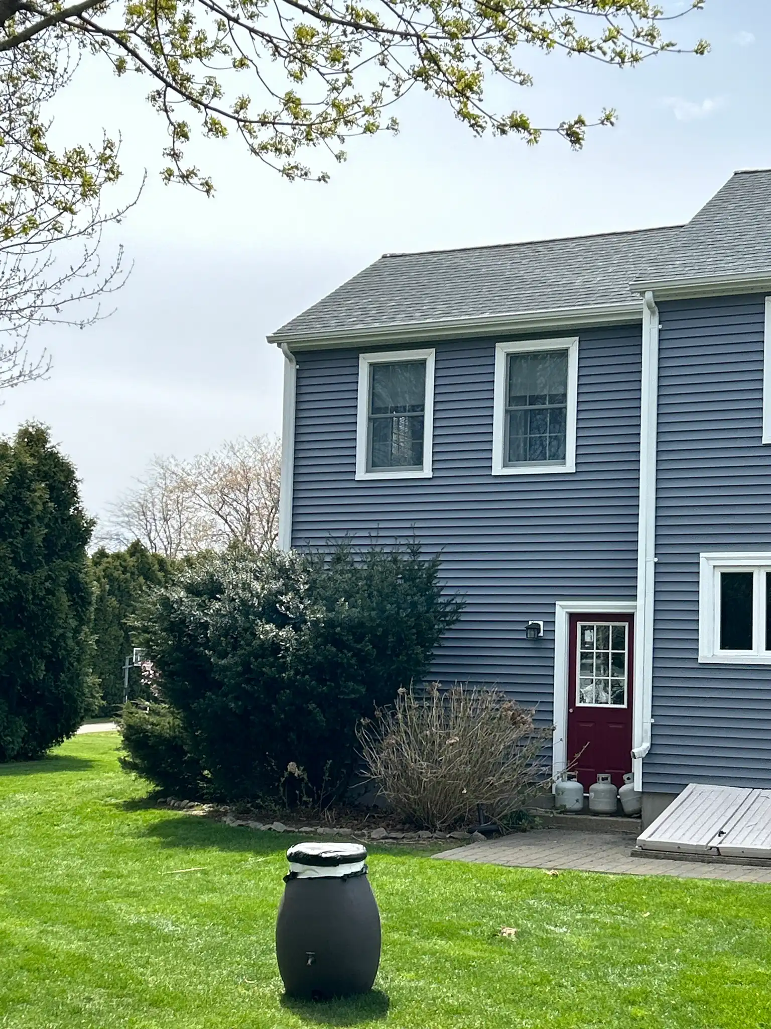Contractors installing standing seam metal roof during residential roof replacement project in Pawcatuck Connecticut home exterior