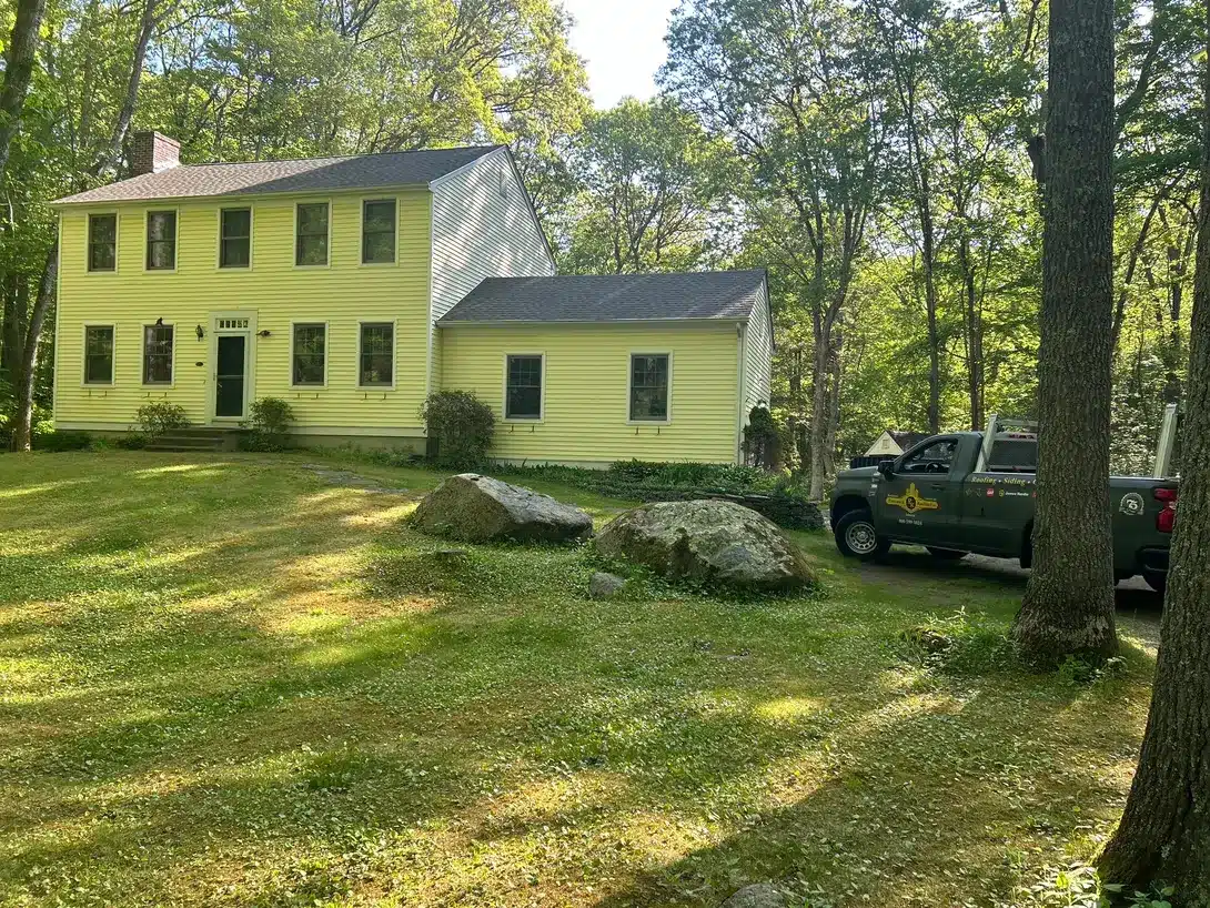 Residential roof replacement and shed roof installation completed by Pawcatuck Roofing Company in Stonington, CT featuring new asphalt shingles and a professionally finished roofing system.