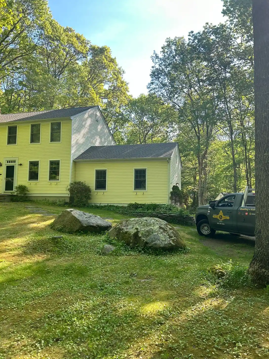 Newly completed residential roof replacement and shed roof installation by Pawcatuck Roofing Company in Stonington, CT showcasing durable asphalt shingles and quality workmanship.