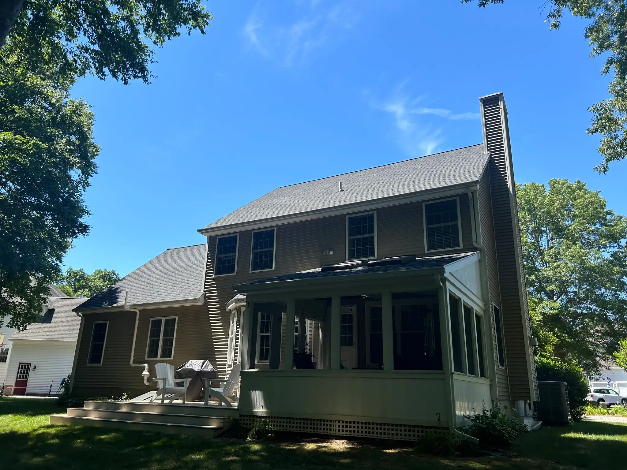 Residential roof replacement and skylight installation completed by Pawcatuck Roofing Company in Groton, CT featuring new asphalt shingles and a professionally installed skylight.