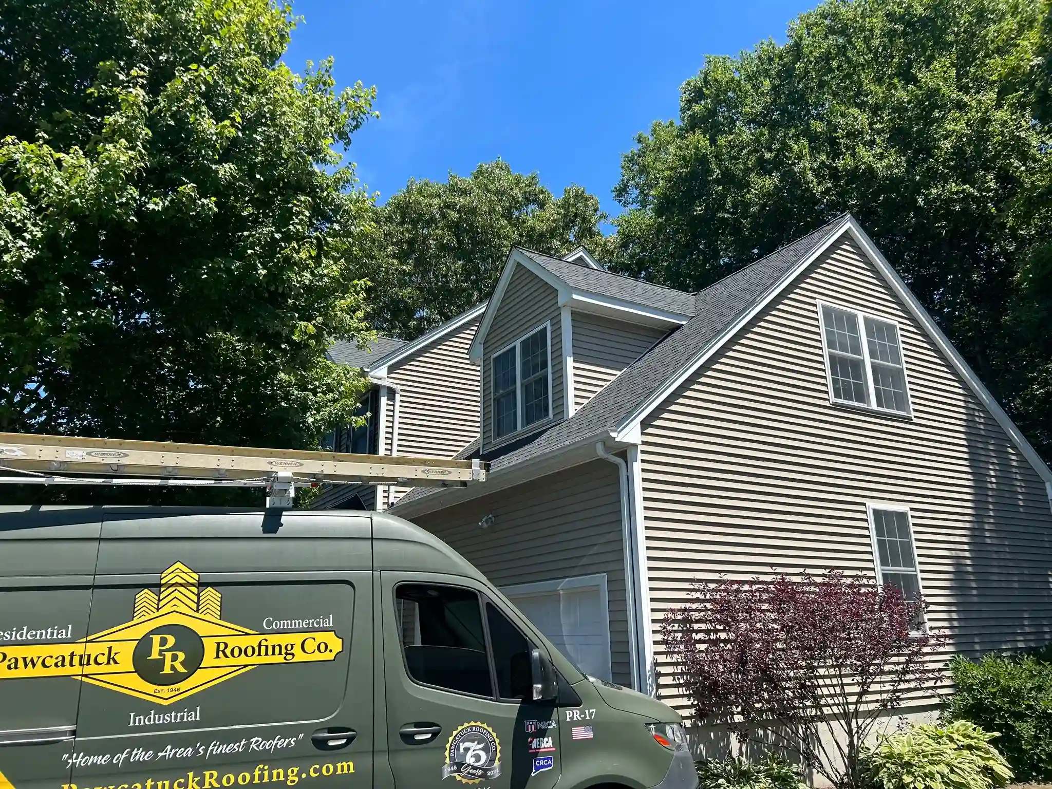 Completed residential roof replacement and skylight installation by Pawcatuck Roofing Company in Groton, CT featuring durable asphalt shingles and a watertight skylight installation.