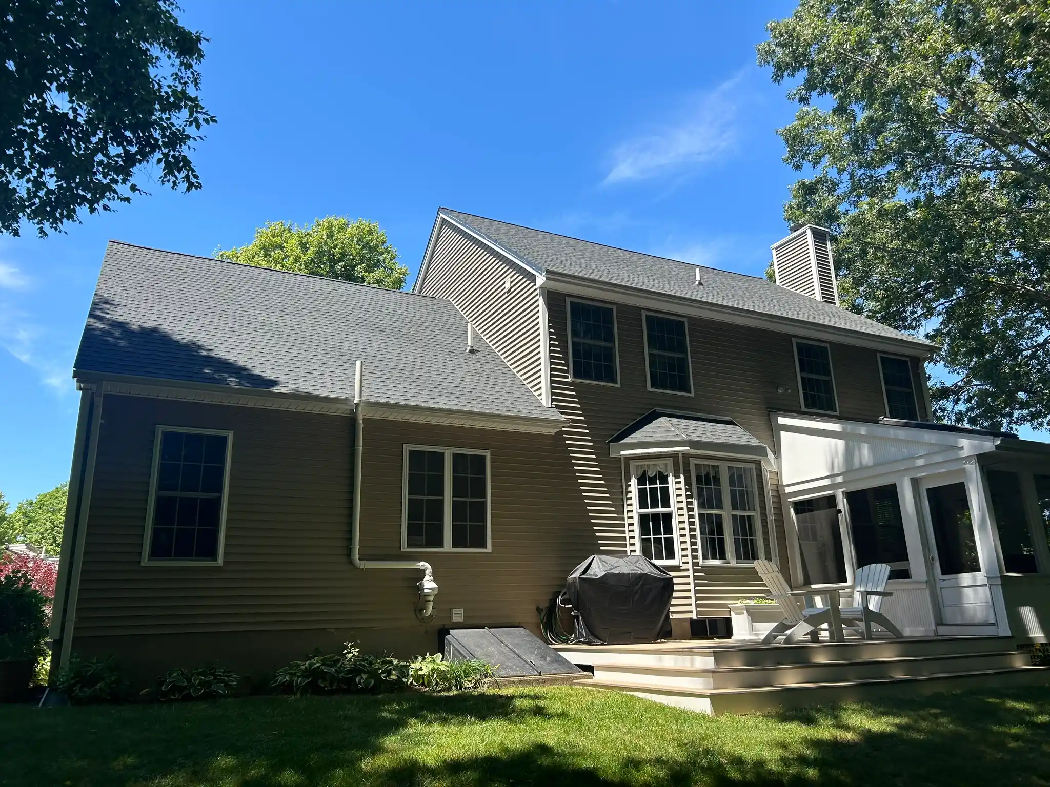 Residential roof replacement with new skylight installation by Pawcatuck Roofing Company in Groton, CT showcasing high-quality asphalt shingles and expert roofing craftsmanship.