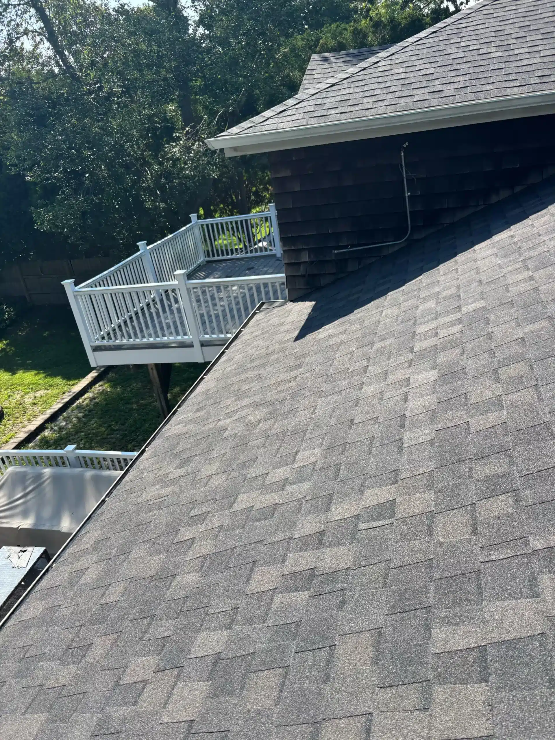 Completed residential roof replacement with adjusted gutter brackets and new gutter guards in Mystic, CT